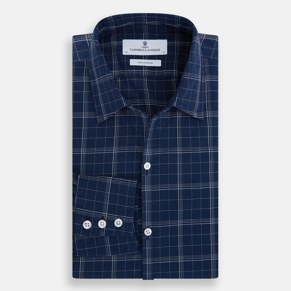 The Indigo and White Thin Plaid Check Windsor Shirt by Turnbull & Asser, a long-sleeve button-up with white buttons, is shown laid flat on a white background.
