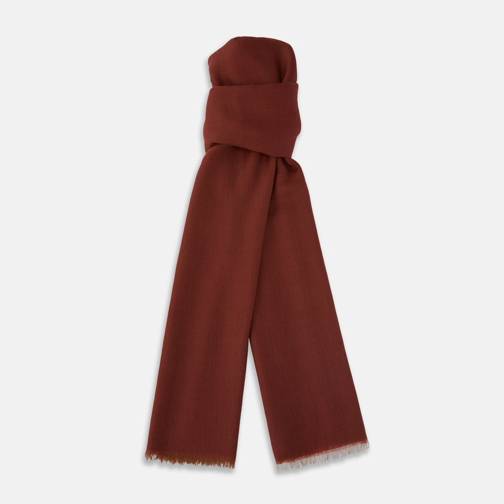 The Plush Burgundy Cashmere Scarf by Turnbull & Asser is neatly folded and draped, featuring subtle frayed edges, and displayed on a plain light background.