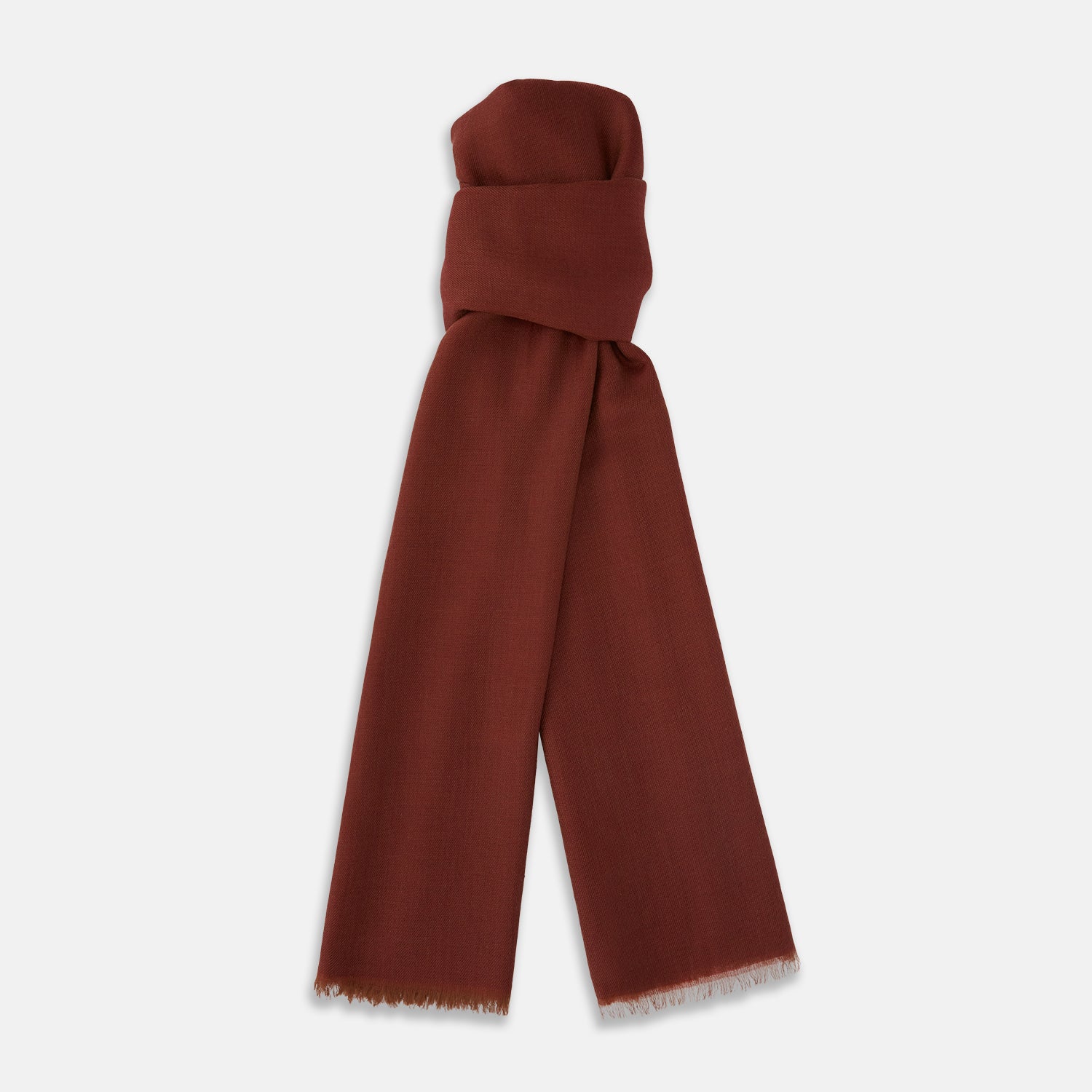 View 1 of product The Plush Burgundy Cashmere Scarf by Turnbull & Asser is neatly folded and draped, featuring subtle frayed edges, and displayed on a plain light background.