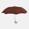 View 1 of product A fully opened Turnbull & Asser Burgundy Telescopic Umbrella with a brown maple crook handle, displayed against a plain white background—a refined men's accessory.