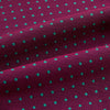 View 4 of product A burgundy pocket square with turquoise polka dots, folded to a point—an ideal men's formal accessory to complement the Green Micro Dot and Magenta Silk Cravat by Turnbull & Asser.