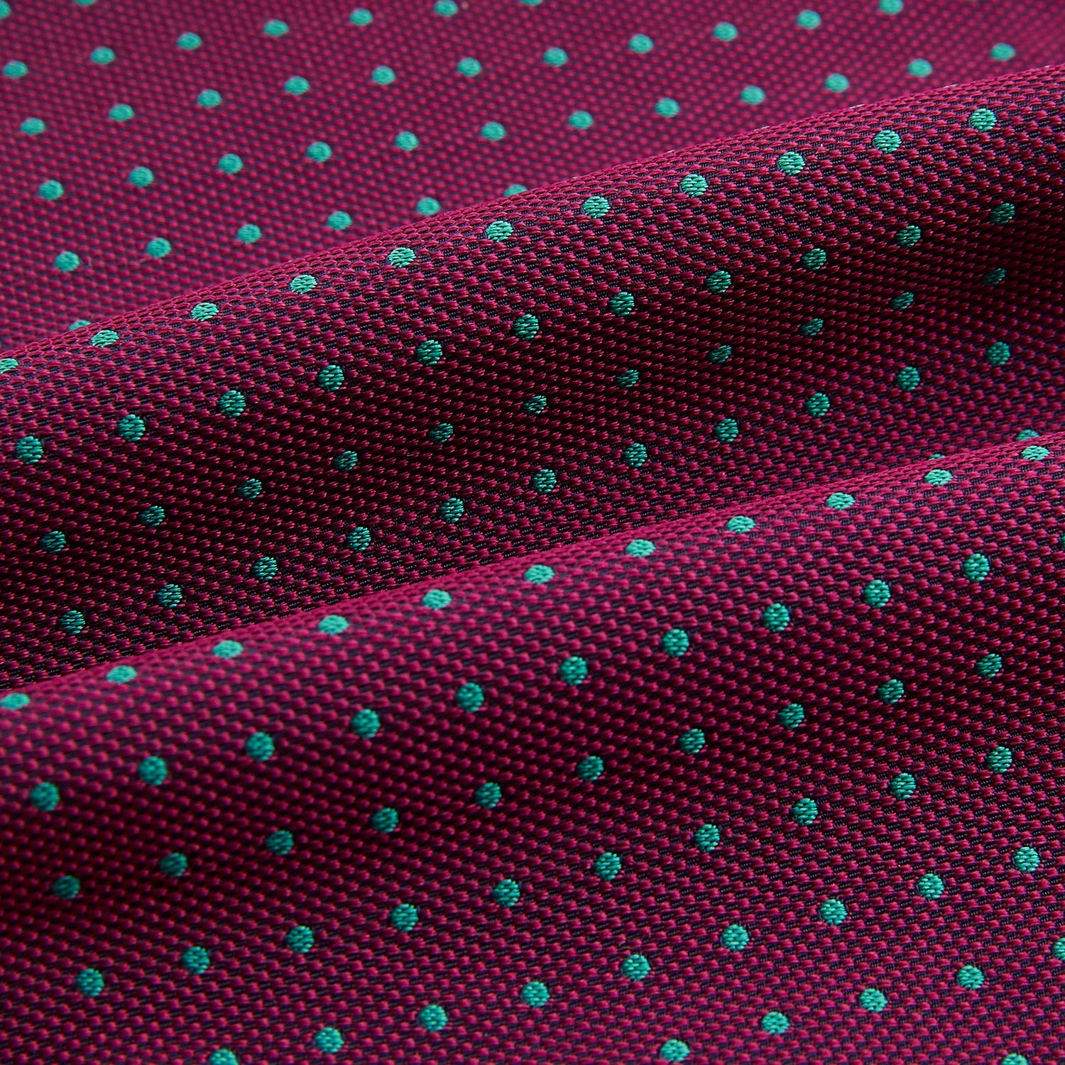 View 4 of product A burgundy pocket square with turquoise polka dots, folded to a point—an ideal men's formal accessory to complement the Green Micro Dot and Magenta Silk Cravat by Turnbull & Asser.
