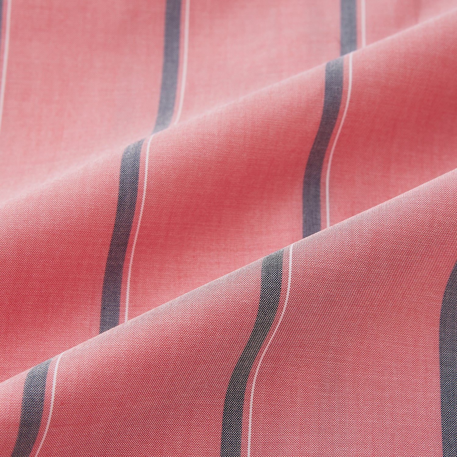 View 8 of product The Coral Pink Track Stripe Westminster Shirt by Turnbull & Asser features vertical navy and white stripes, a tailored fit, pointed collar, and buttoned cuffs—is displayed laid flat on a white background.