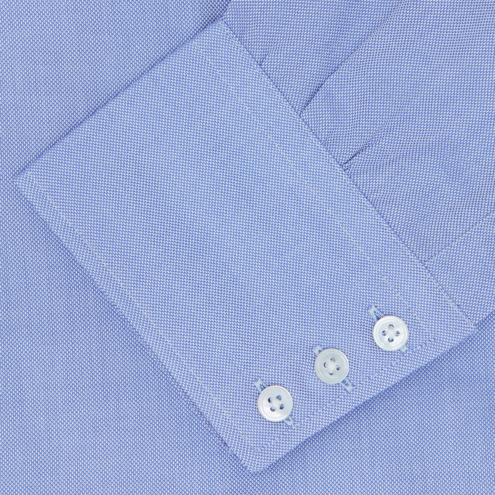 The Turnbull & Asser Blue Royal Oxford Cotton Shirt features a button-down collar, 3-button cuffs, and a visible brand label, shown neatly folded on a white background—ideal for pairing with a navy suit.