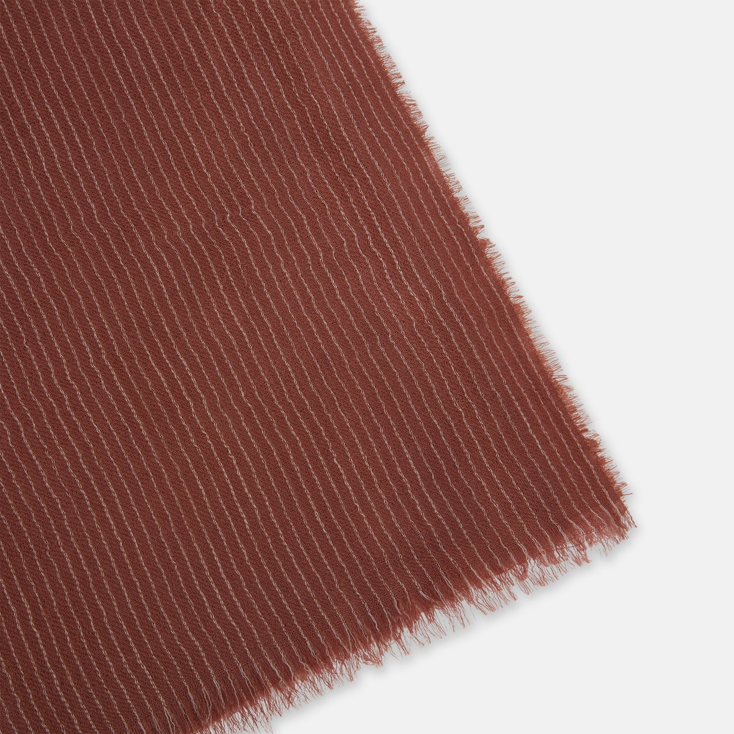 View 2 of product A Burgundy and White Striped Cashmere Scarf by Turnbull & Asser is neatly folded on a plain, light gray background.
