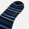 View 3 of product Turnbull & Asser Navy Striped Merino Wool Long Socks, knee-high and over the calf, feature horizontal blue and black stripes and are shown on a plain white background.