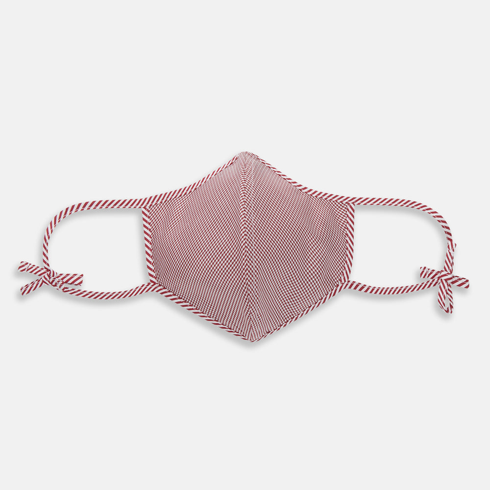 The Turnbull & Asser Burgundy Check Commuter Mask comes with 3 Viroformula™ filters. It features a check pattern, adjustable ear straps, and is displayed on a plain white background.