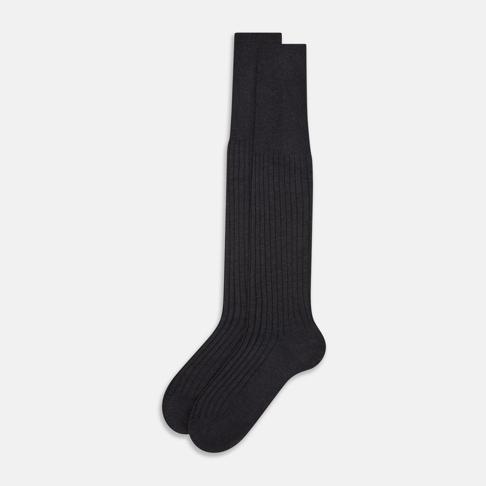 A single Turnbull & Asser Charcoal Long Sock, crafted from mercerised Egyptian cotton with a ribbed texture, is shown on a plain white background, positioned as if worn with the heel slightly raised.