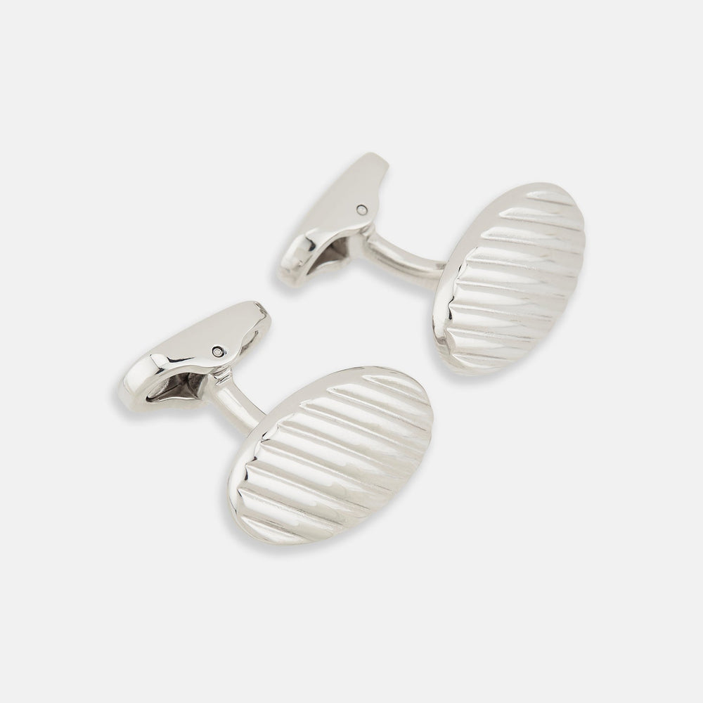 Turnbull & Asser Silver Striped Oval Cufflinks feature a classic diagonal pattern on a silver oval face, displayed against a plain white background.