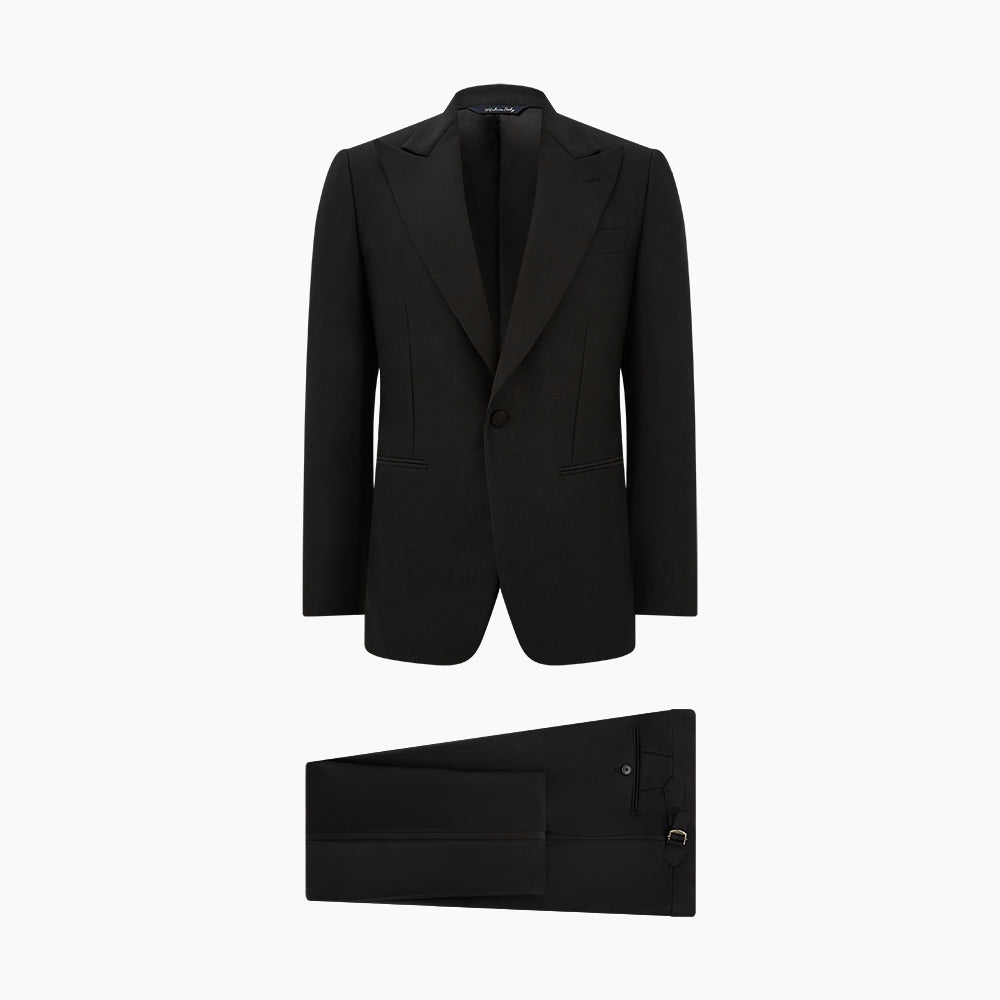 The Turnbull & Asser Black Single Breasted Dinner Suit, with satin lapels and matching trousers, is elegantly folded and displayed on a plain white background.