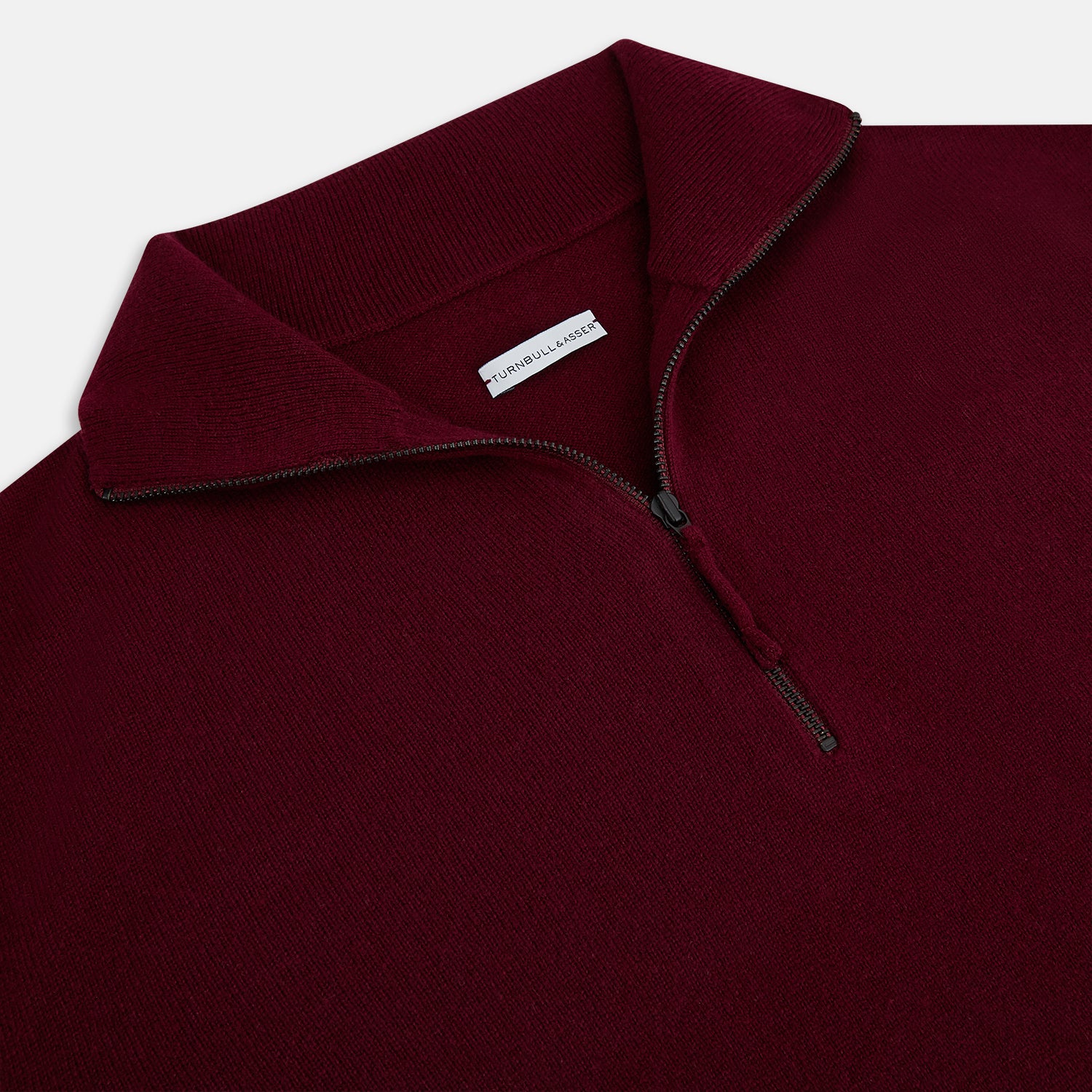View 2 of product The Turnbull & Asser Ruby Red Half-Zip Cashmere Jumper, with a stand-up collar and elegant design, is displayed against a plain white background.