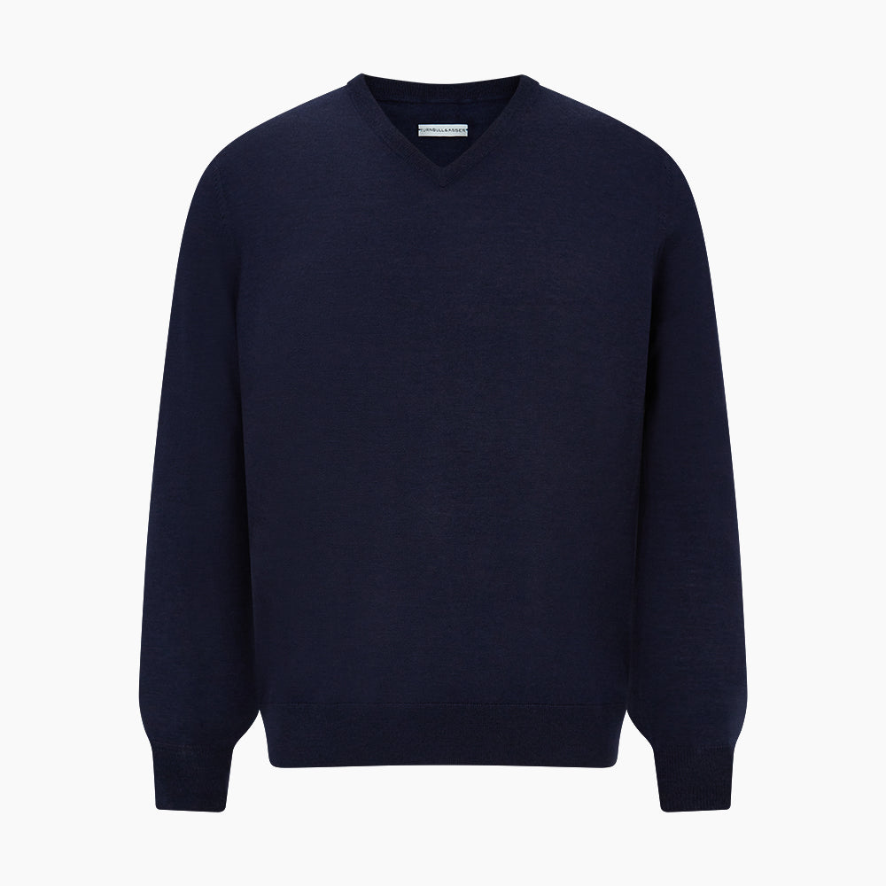 The Turnbull & Asser Navy Fine Merino V-Neck Jumper is displayed against a white background, featuring ribbed cuffs and hem for timeless style in a classic, plain long-sleeve design.