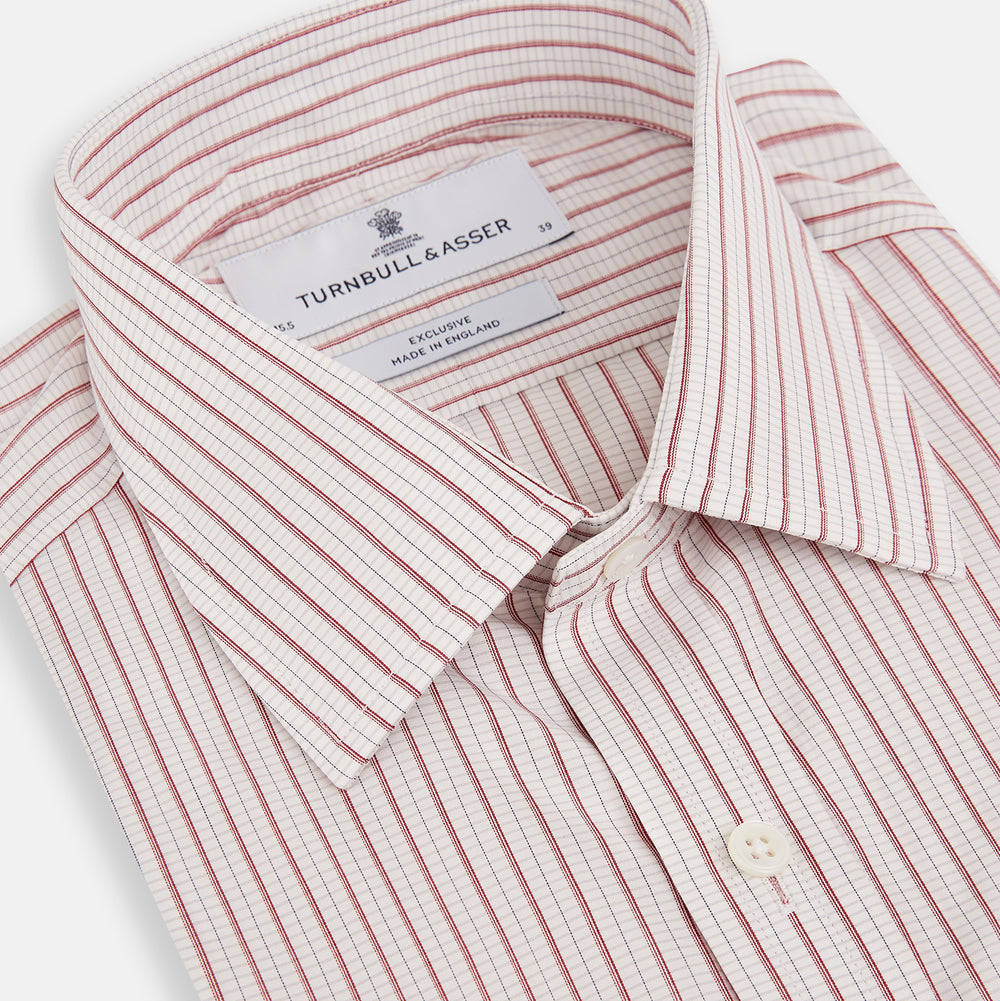 The Turnbull & Asser Red Graph Check Mayfair Shirt features a classic collar and buttoned cuffs, with red and blue stripes on white, ideal for formal wear. Laid flat on a white surface.
