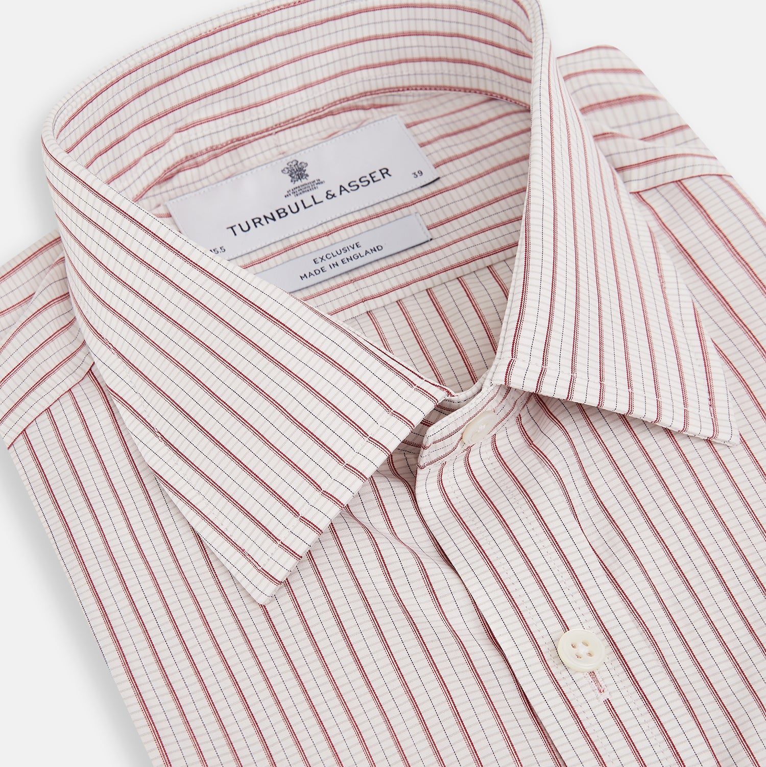 View 2 of product The Turnbull & Asser Red Graph Check Mayfair Shirt features a classic collar and buttoned cuffs, with red and blue stripes on white, ideal for formal wear. Laid flat on a white surface.