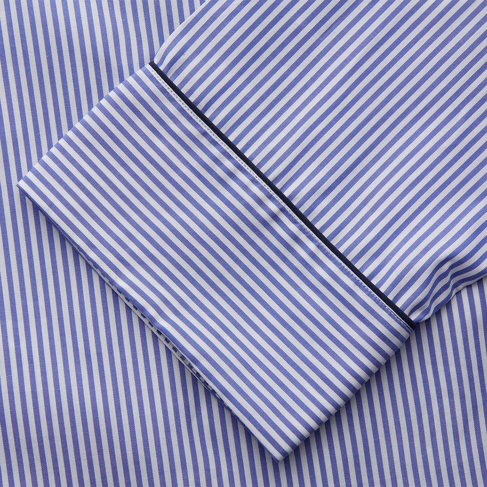 The Turnbull & Asser Women's Harriet Blue Bengal Stripe Pyjama Set features premium cotton, a long-sleeve button-up top with chest pocket, and drawstring pants—an ideal gift option.
