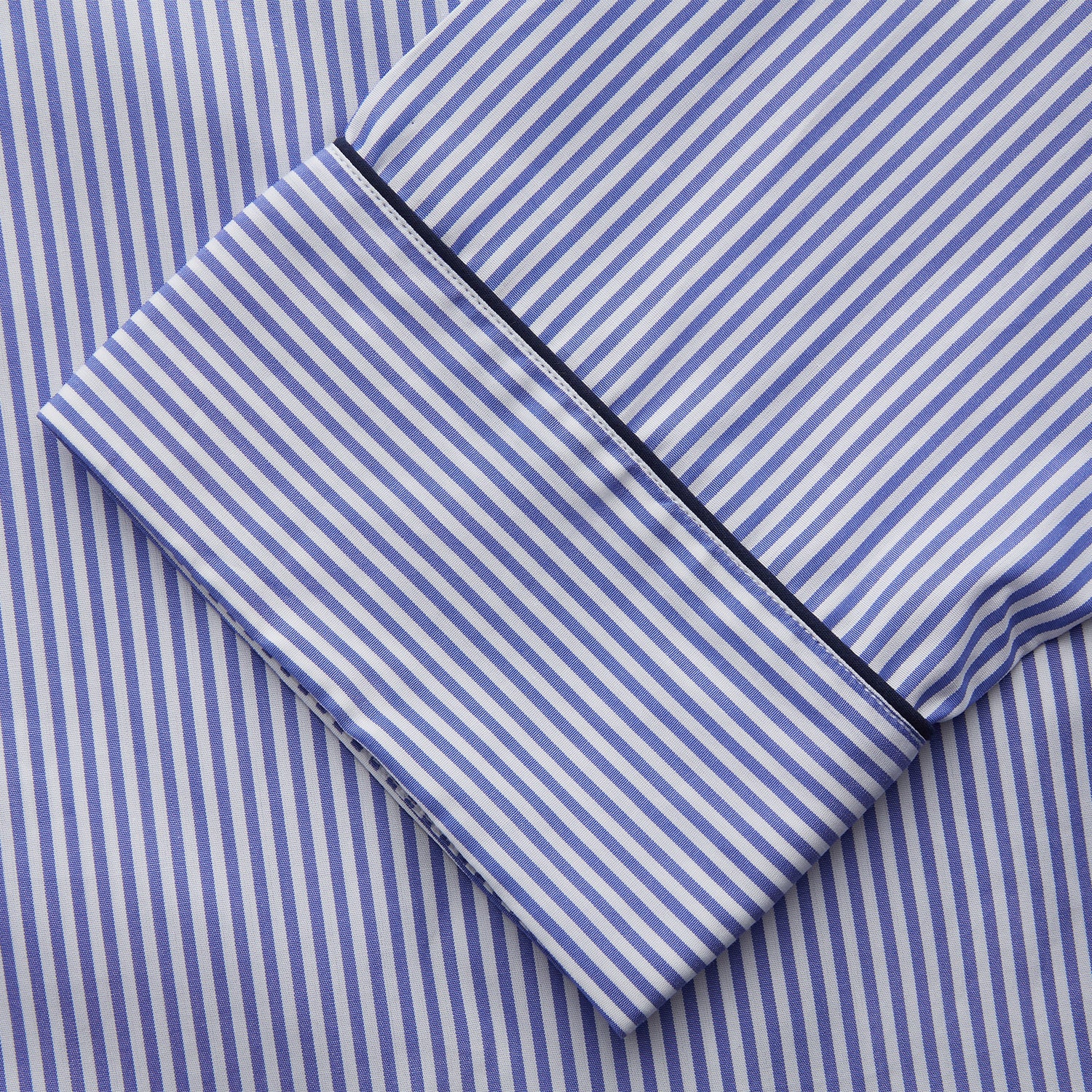 View 4 of product The Turnbull & Asser Women's Harriet Blue Bengal Stripe Pyjama Set features premium cotton, a long-sleeve button-up top with chest pocket, and drawstring pants—an ideal gift option.