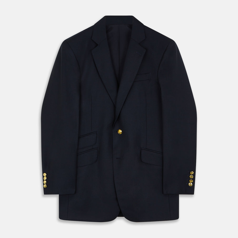 The Turnbull & Asser Navy Plain Wool Single Breasted Blazer, with brass front and cuff buttons and an asymmetric pocket design, is shown laid flat on a white background.