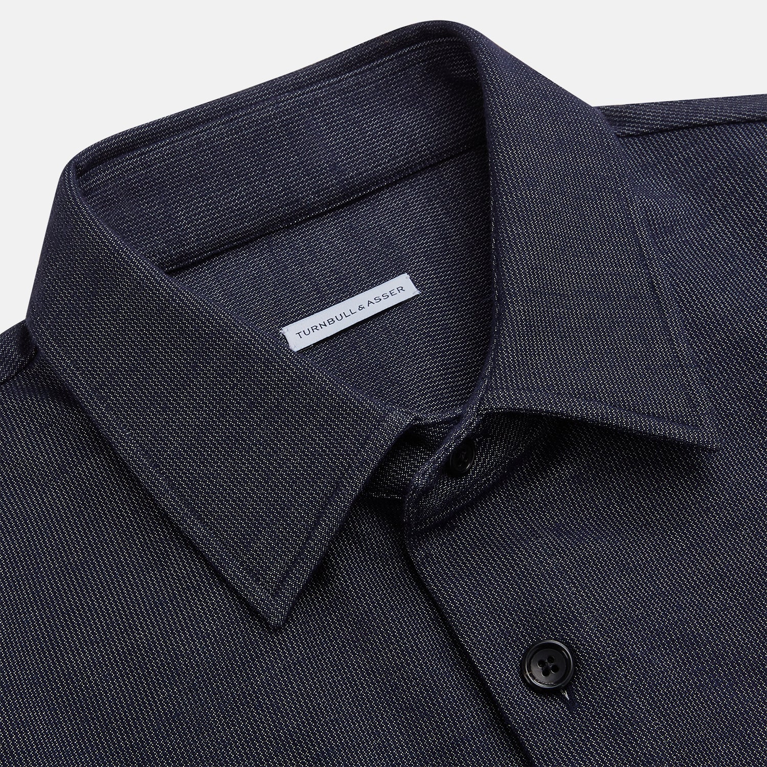 View 2 of product The Turnbull & Asser Navy Hampstead Overshirt features a collar, left chest pocket, two zippered pockets near the bottom, and a classic long-sleeve button-up design, shown laid flat on a white background.