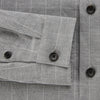 View 4 of product The Turnbull & Asser Grey Check Hampstead Overshirt features a light gray check pattern, pointed collar, chest pocket, and two zippered side pockets, displayed flat against a white background.