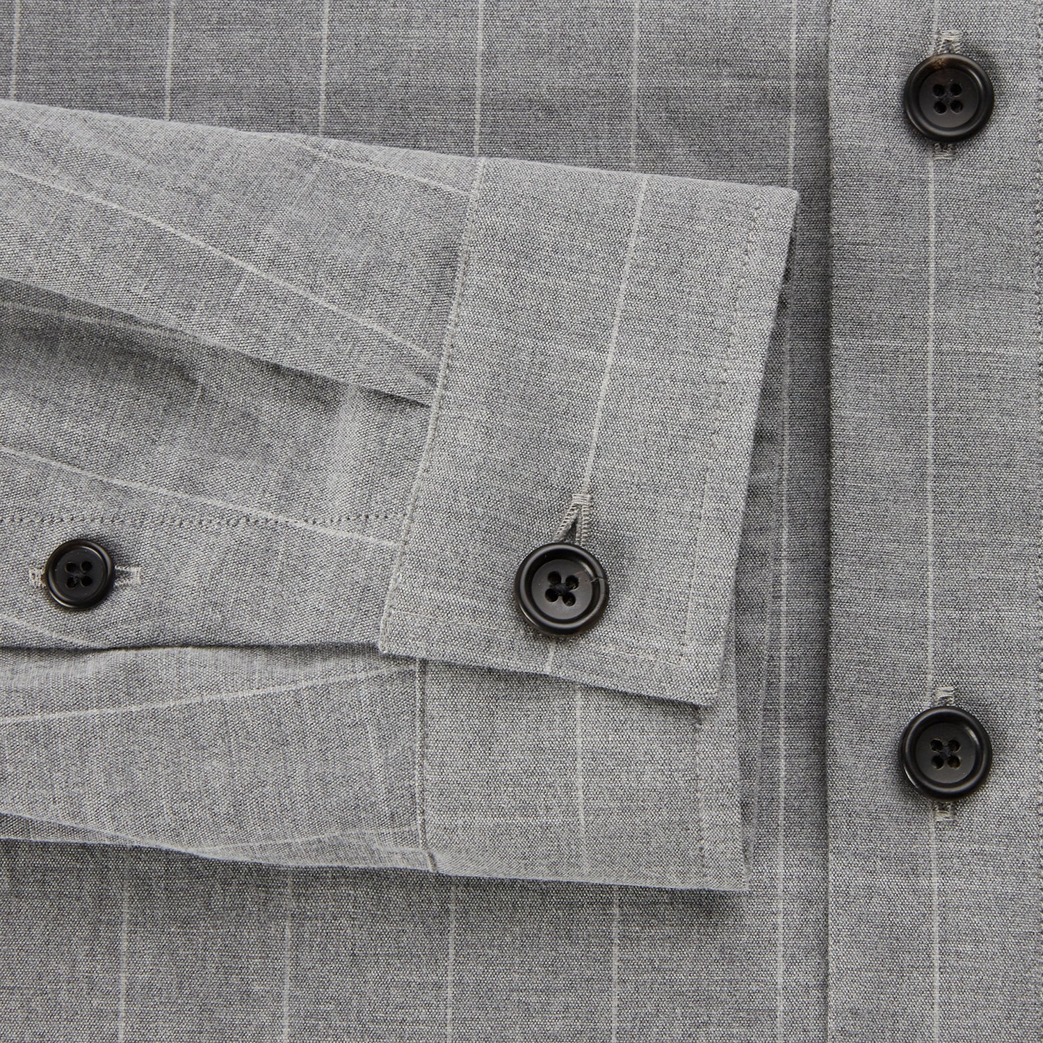 View 4 of product The Turnbull & Asser Grey Check Hampstead Overshirt features a light gray check pattern, pointed collar, chest pocket, and two zippered side pockets, displayed flat against a white background.