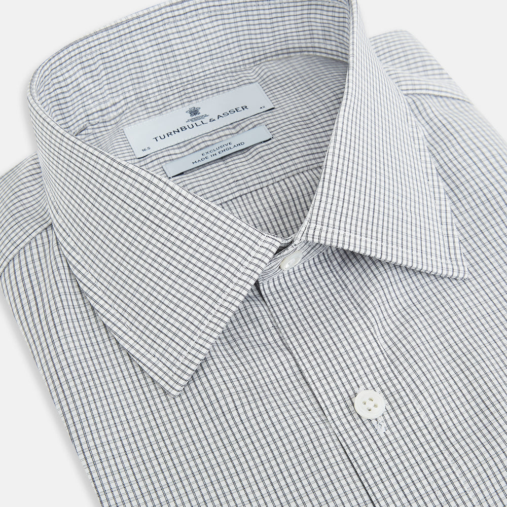The Midnight Blue Micro Tattersall Check Mayfair Shirt by Turnbull & Asser, made from pure cotton with white buttons, a classic collar, and cuffed sleeves, is laid flat on a white background.