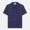 View 2 of product The Navy Silk Holiday Fit Phillips Shirt by Turnbull & Asser features short sleeves, a revere collar, and three front patch pockets, shown laid flat on a white background.