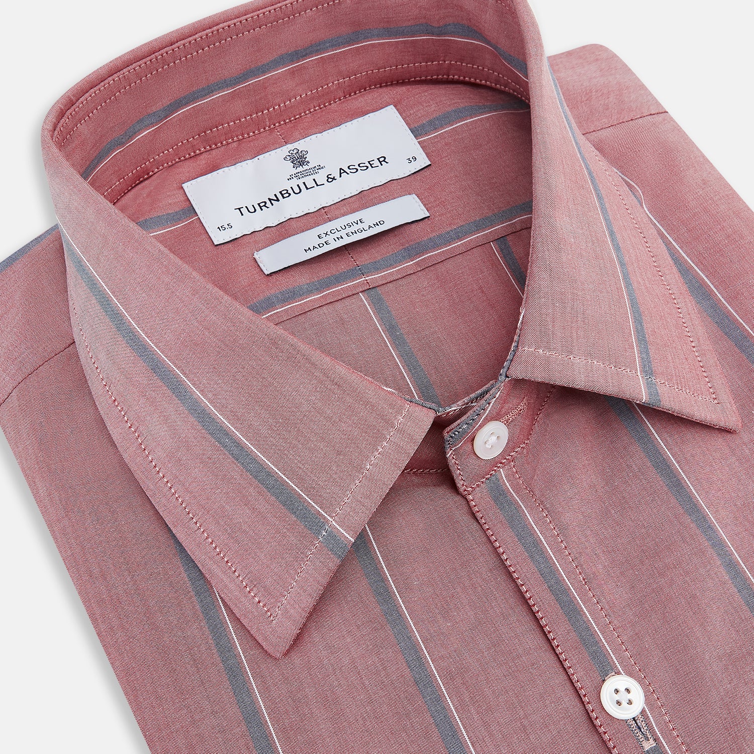 View 2 of product The Turnbull & Asser Red Track Stripe Westminster Shirt features British craftsmanship, a collar, pink base with vertical blue and white stripes, white buttons, and a pocket-free front for refined appeal.