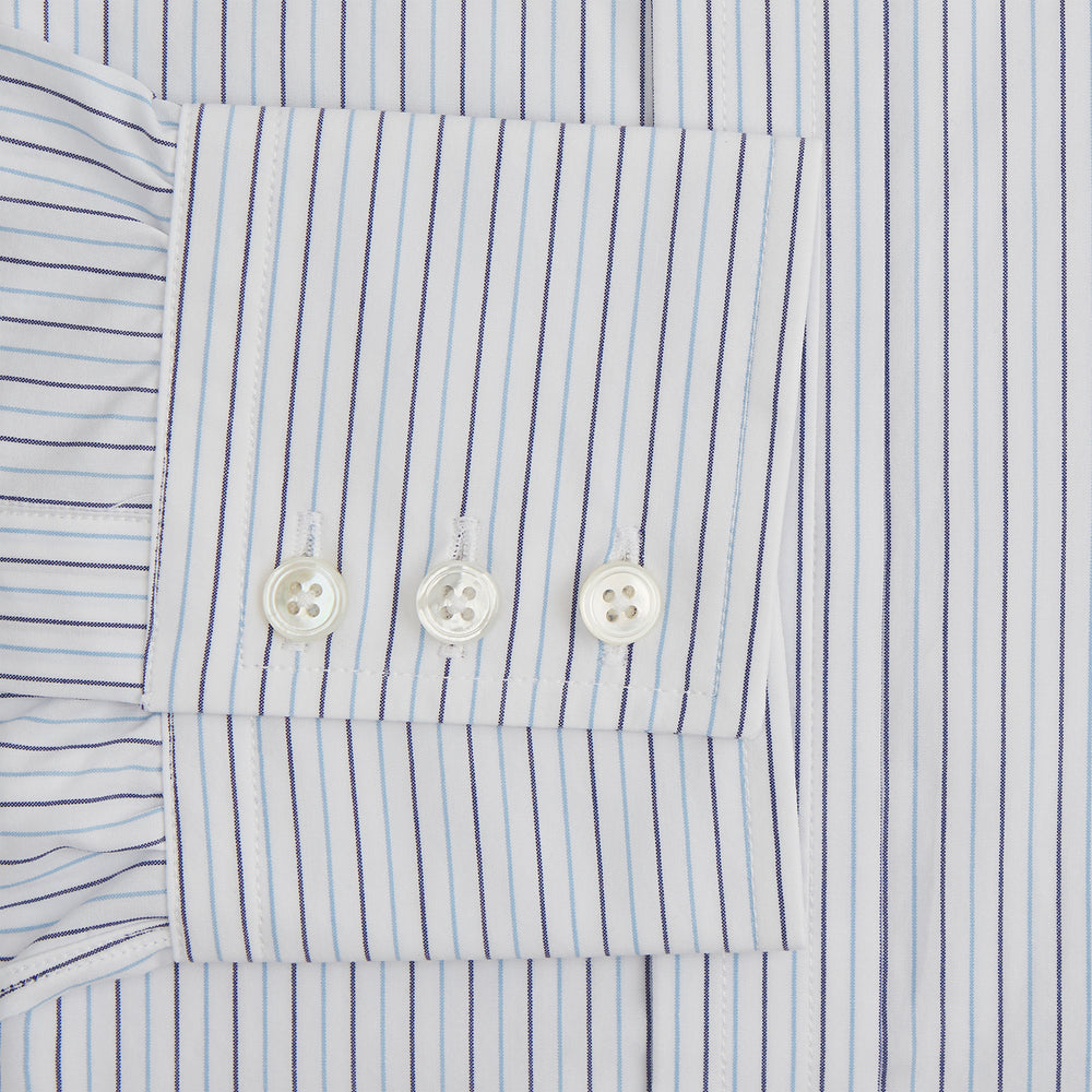 The Blue Double Pinstripe Mayfair Shirt by Turnbull & Asser is made from organic cotton with thin blue and white stripes, a pointed collar, and buttoned cuffs—perfect for elevating your workweek rotation.