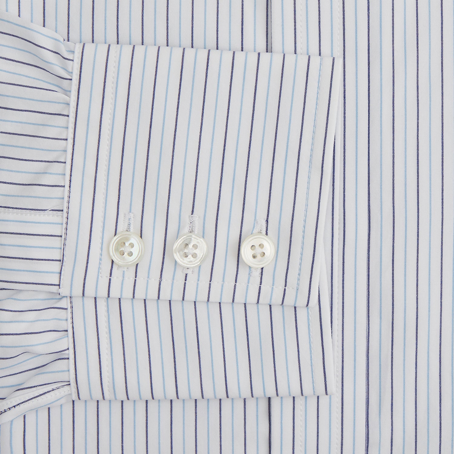 View 3 of product The Blue Double Pinstripe Mayfair Shirt by Turnbull & Asser is made from organic cotton with thin blue and white stripes, a pointed collar, and buttoned cuffs—perfect for elevating your workweek rotation.