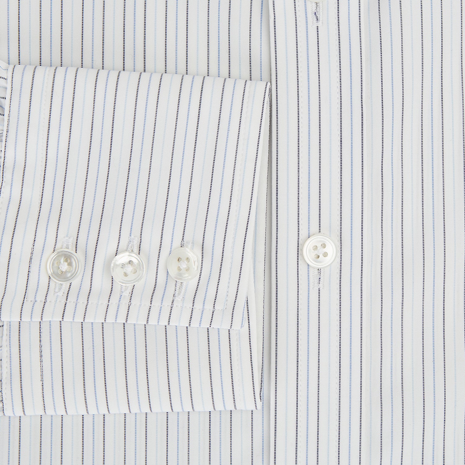 View 4 of product The Turnbull & Asser Blue Multi-Tone Double Pinstripe Mayfair Shirt, crafted from premium Italian cotton with a pointed collar, buttoned cuffs, and long sleeves, is shown on a plain white background.
