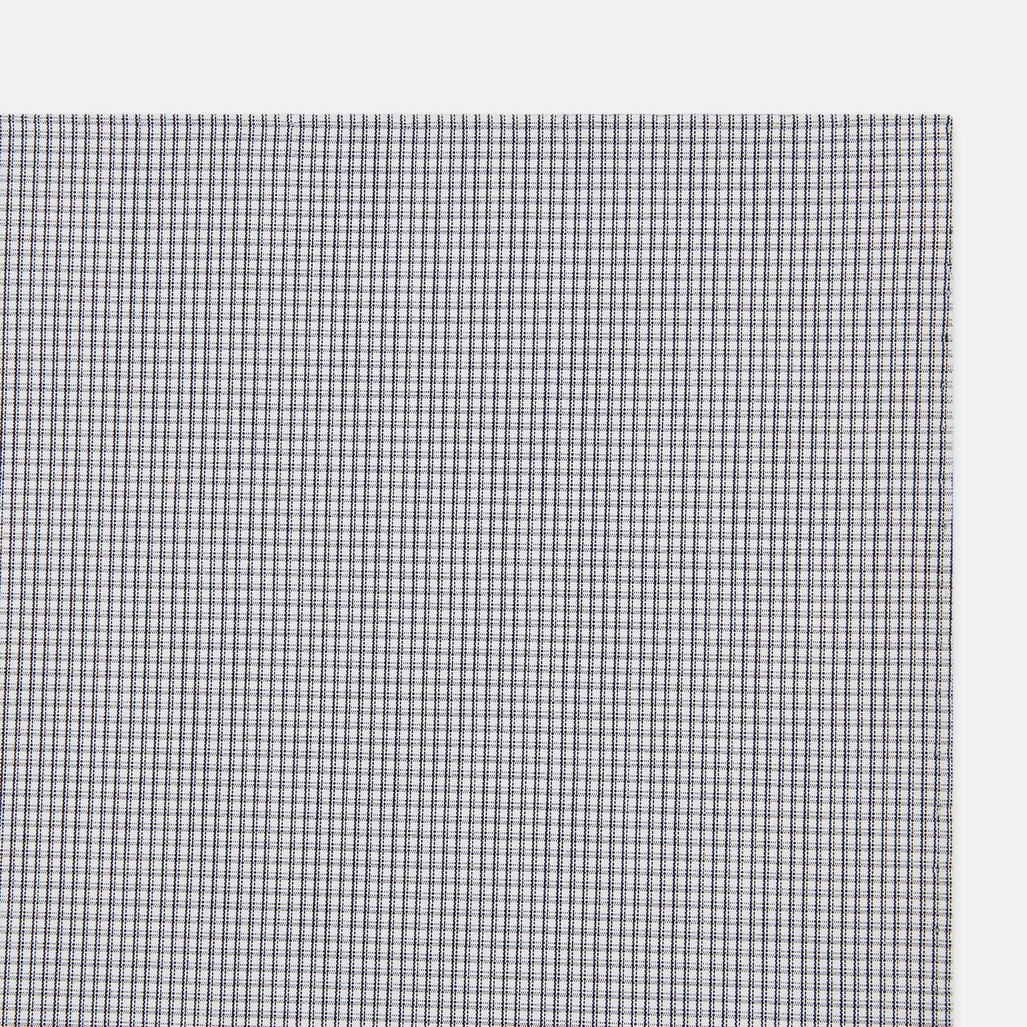 View 2 of product The Turnbull & Asser Navy Blue Shadow Grid Check Hand-Rolled Handkerchief showcases a small, evenly spaced blue and white check pattern and hand-rolled edges, neatly displayed against a white background.