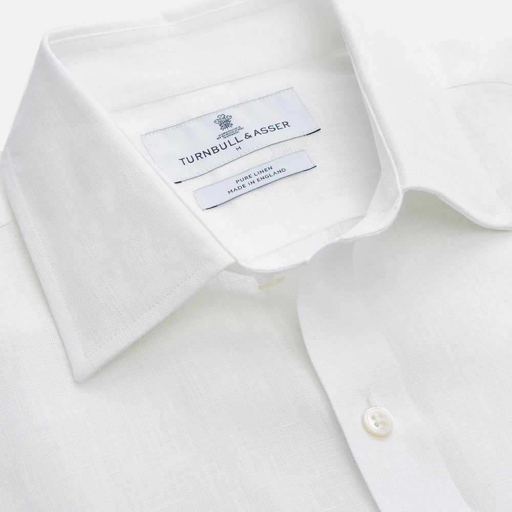 The Turnbull & Asser White Weekend Fit Linen Finch Shirt features a Derby collar and chest pocket, laid flat on a white background—an effortlessly classic choice for casual weekends.
