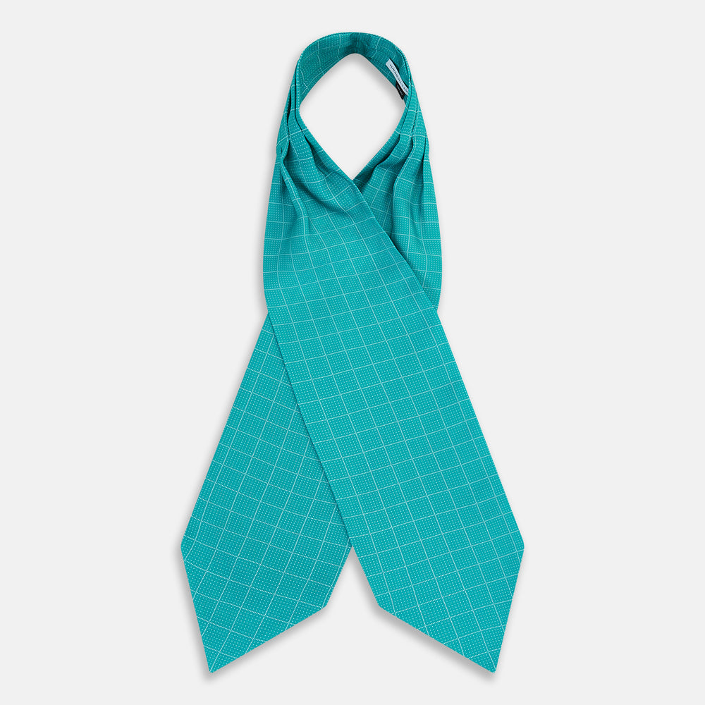 The Turquoise Dotted Check Pattern Printed Silk Cravat by Turnbull & Asser features a neatly folded diamond shape and a refined white dotted grid, showcasing classic style.