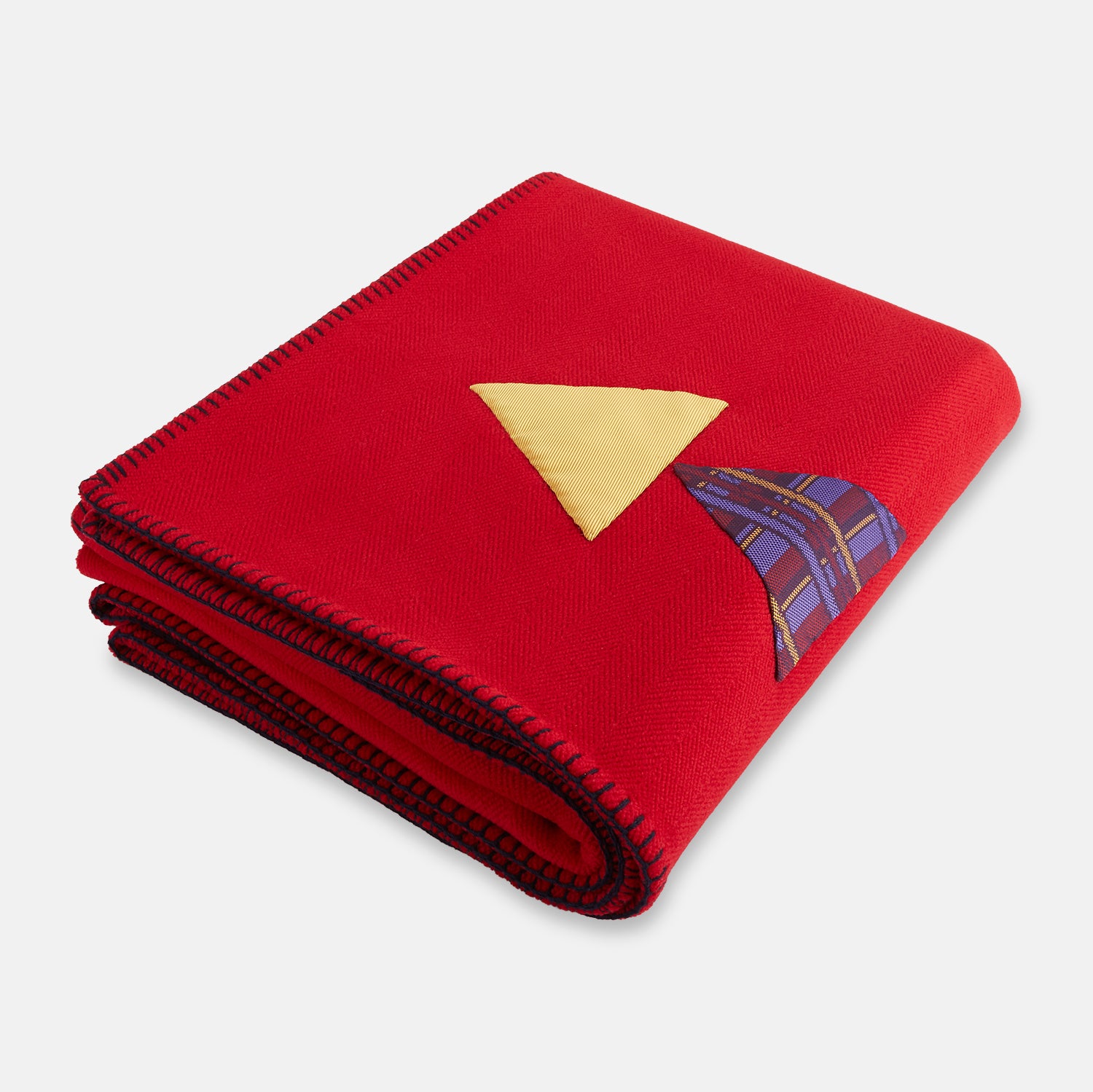 View 2 of product The Turnbull & Asser Red Applique Hand Stitched Lambswool Blanket features black-stitched edges and handsewn tie silk patches, including a yellow triangle and plaid triangle arranged to form a stylized fish.
