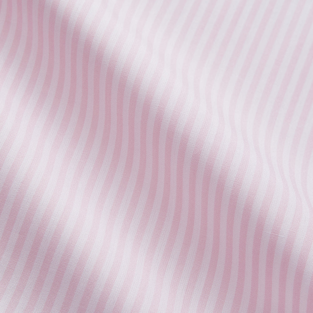 The Turnbull & Asser White and Pink Wide Stripe Mayfair Shirt features long sleeves, a collar, and bold vertical stripes, shown laid flat on a white background.