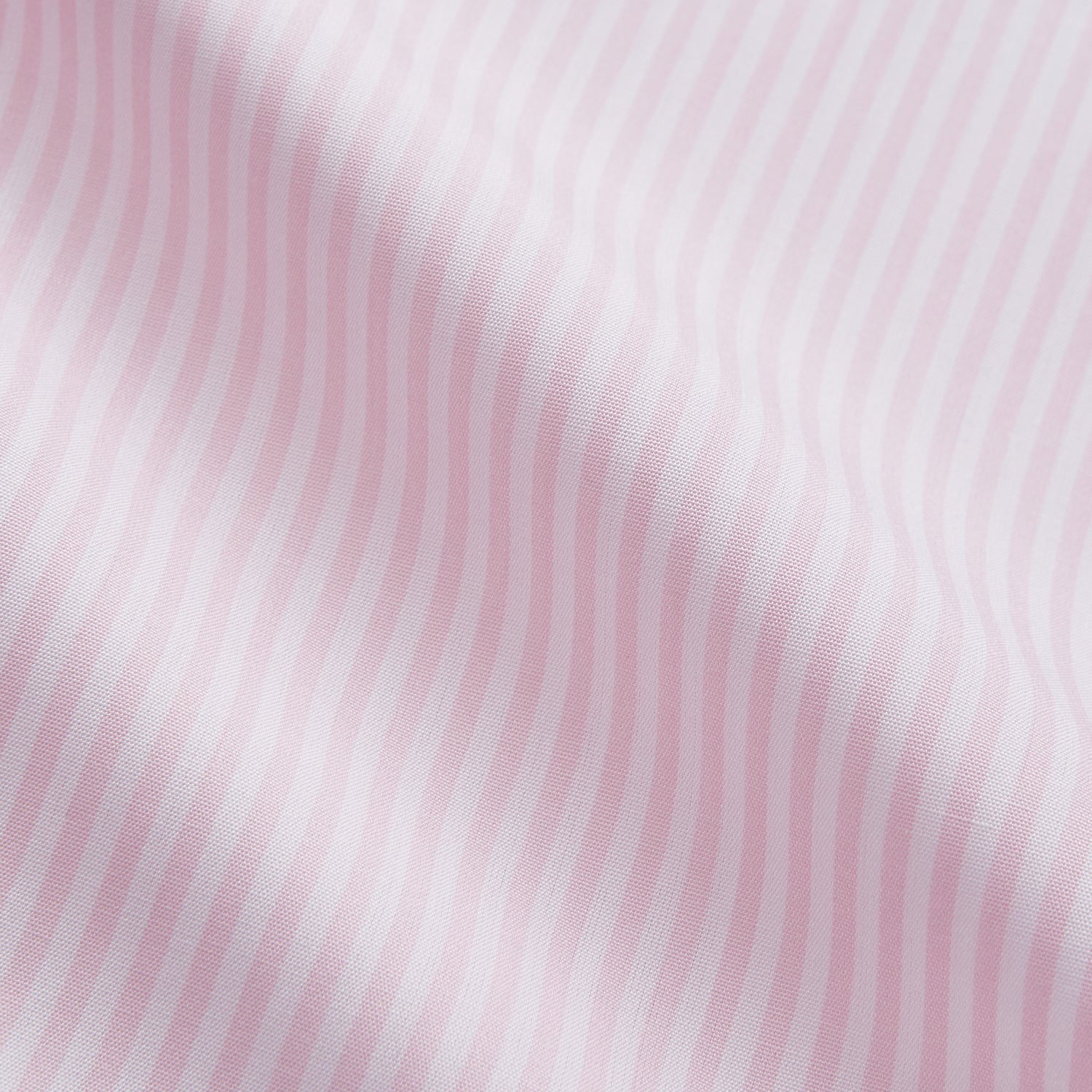 View 2 of product The Turnbull & Asser White and Pink Wide Stripe Mayfair Shirt features long sleeves, a collar, and bold vertical stripes, shown laid flat on a white background.