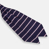 View 3 of product The Turnbull & Asser Pink Stripe and Navy Silk Cravat features evenly spaced light pink stripes on navy silk—a refined British style wedding accessory, elegantly displayed against a white background.