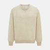 View 1 of product The Turnbull & Asser Cream Cashmere Round Neck Jumper features long sleeves, ribbed cuffs, and a ribbed hem—a versatile men’s knitwear staple, shown against a white background.