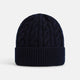 The Turnbull & Asser Midnight Blue Cable Knit Cashmere Beanie features a ribbed folded brim and chunky cable pattern, expertly knitted in England, and shown against a plain white background.