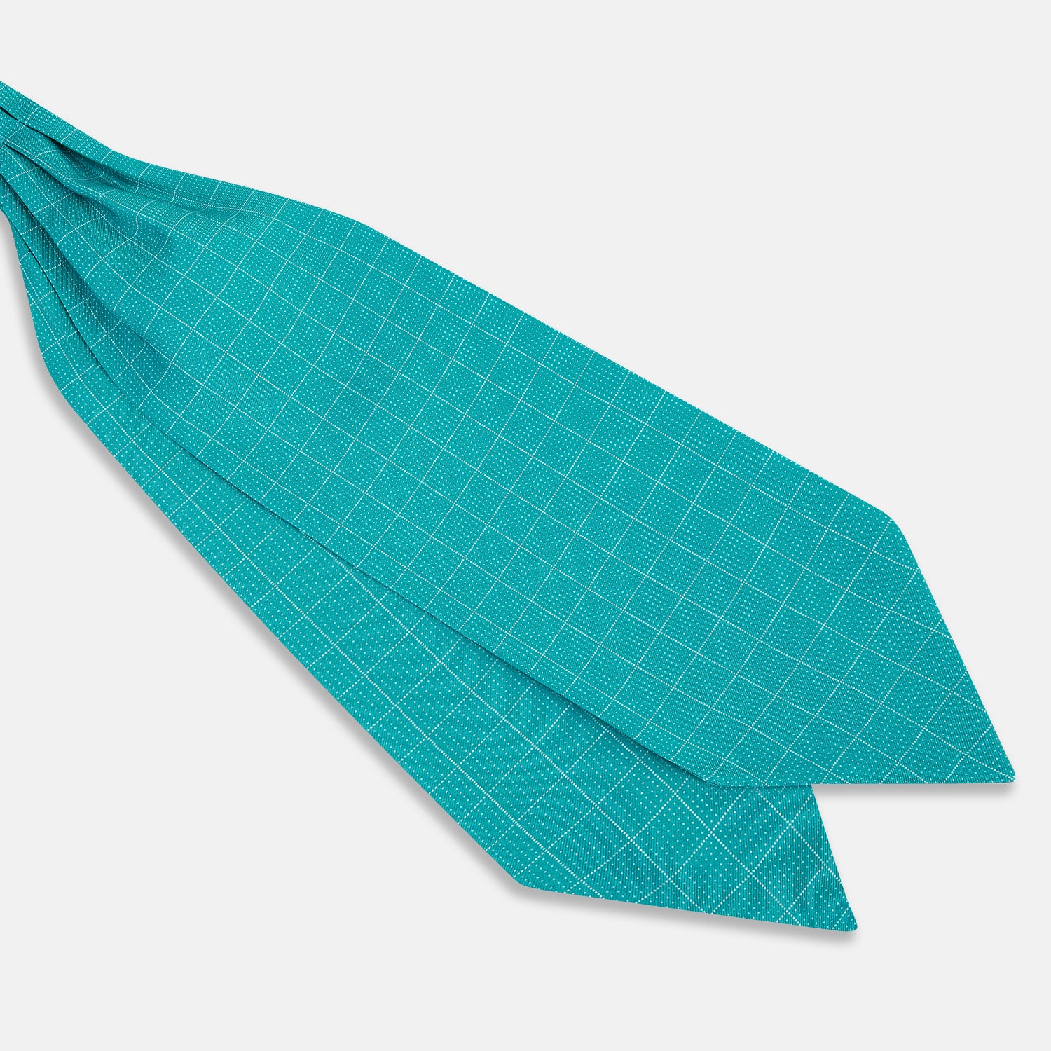 View 2 of product The Turquoise Dotted Check Pattern Printed Silk Cravat by Turnbull & Asser features a neatly folded diamond shape and a refined white dotted grid, showcasing classic style.