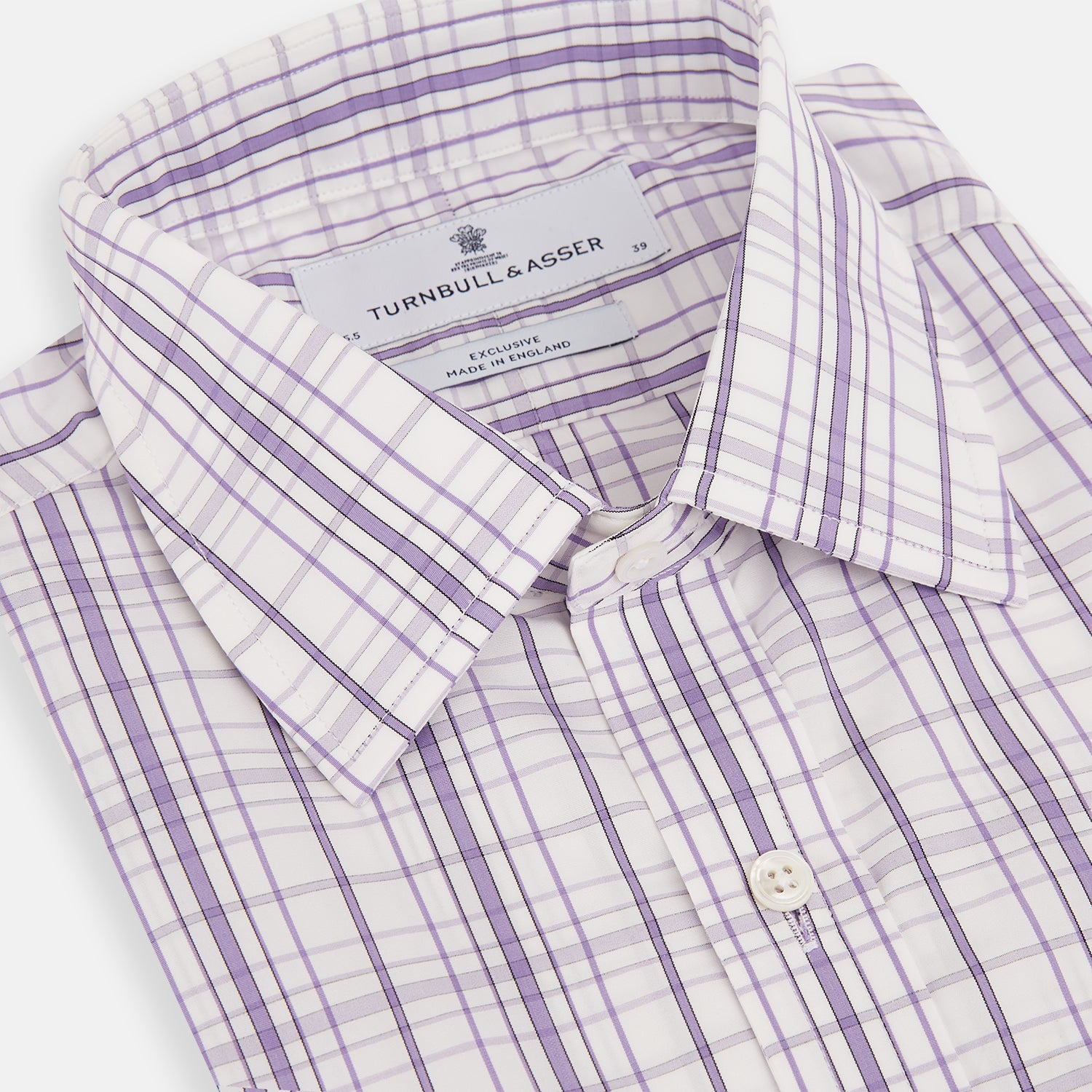 View 2 of product The Turnbull & Asser Purple Plaid Check Mayfair Shirt is a long-sleeve button-down with a pointed T&A collar, featuring a purple and blue plaid pattern on white.