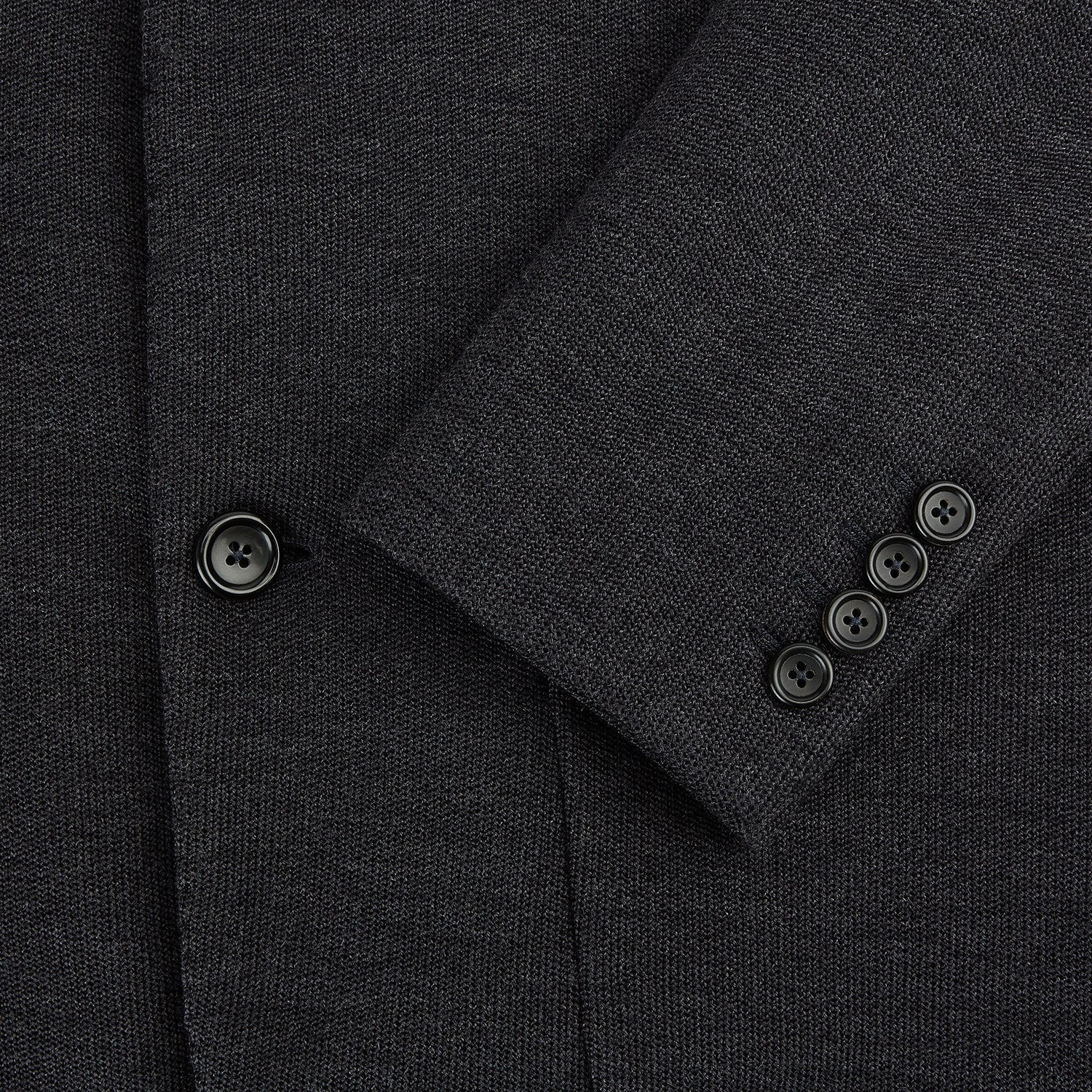 View 4 of product The Turnbull & Asser Charcoal Knitted Oxford Blazer features a notched lapel, two-button closure, and three front pockets, blending modern elegance with British heritage against a plain white background.