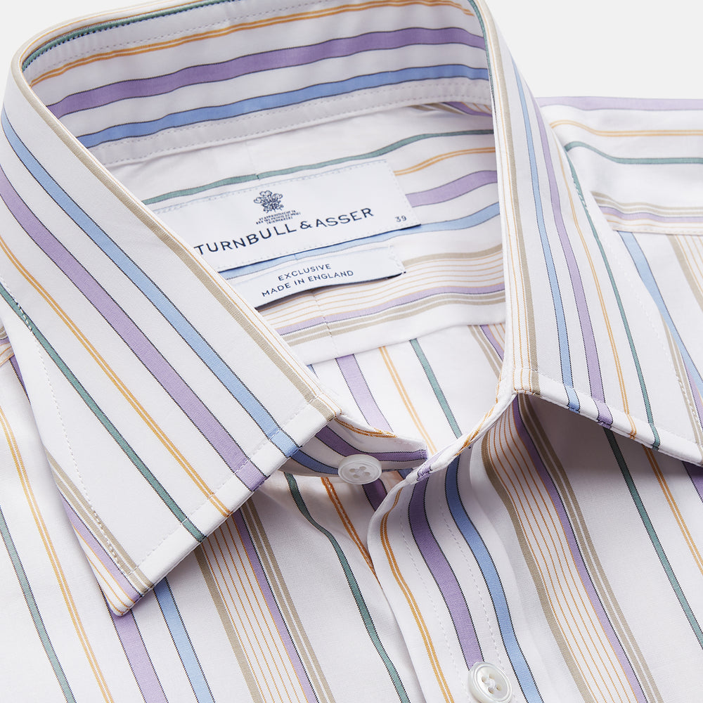 The Colourful Garden Multi Stripe Cotton Regular Fit Mayfair Shirt by Turnbull & Asser features a collar, buttoned cuffs, and vertical stripes in blue, yellow, pink, and white on a light background for a relaxed look.
