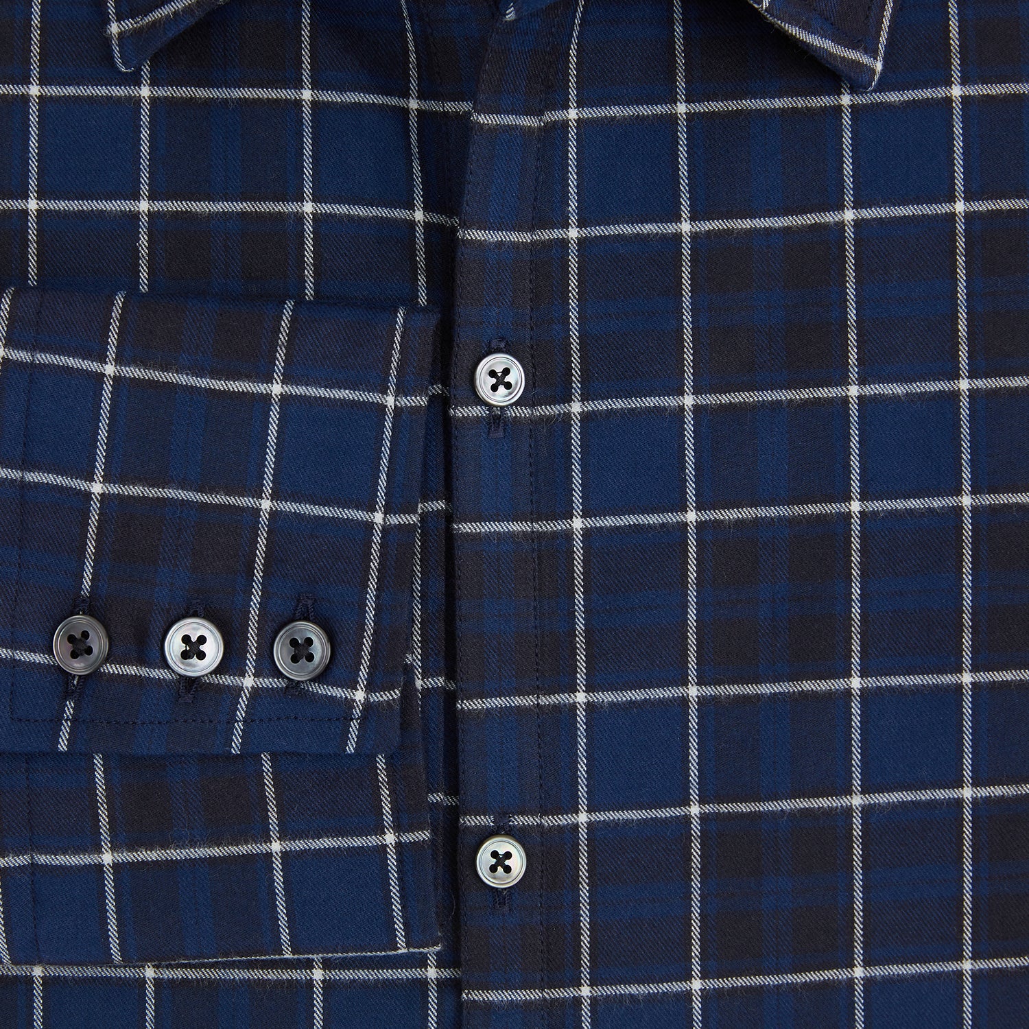 View 4 of product The Turnbull & Asser Navy and White Check Windsor Shirt features a long-sleeve design with a navy base and white check pattern, showcasing British craftsmanship and displayed on a white background.