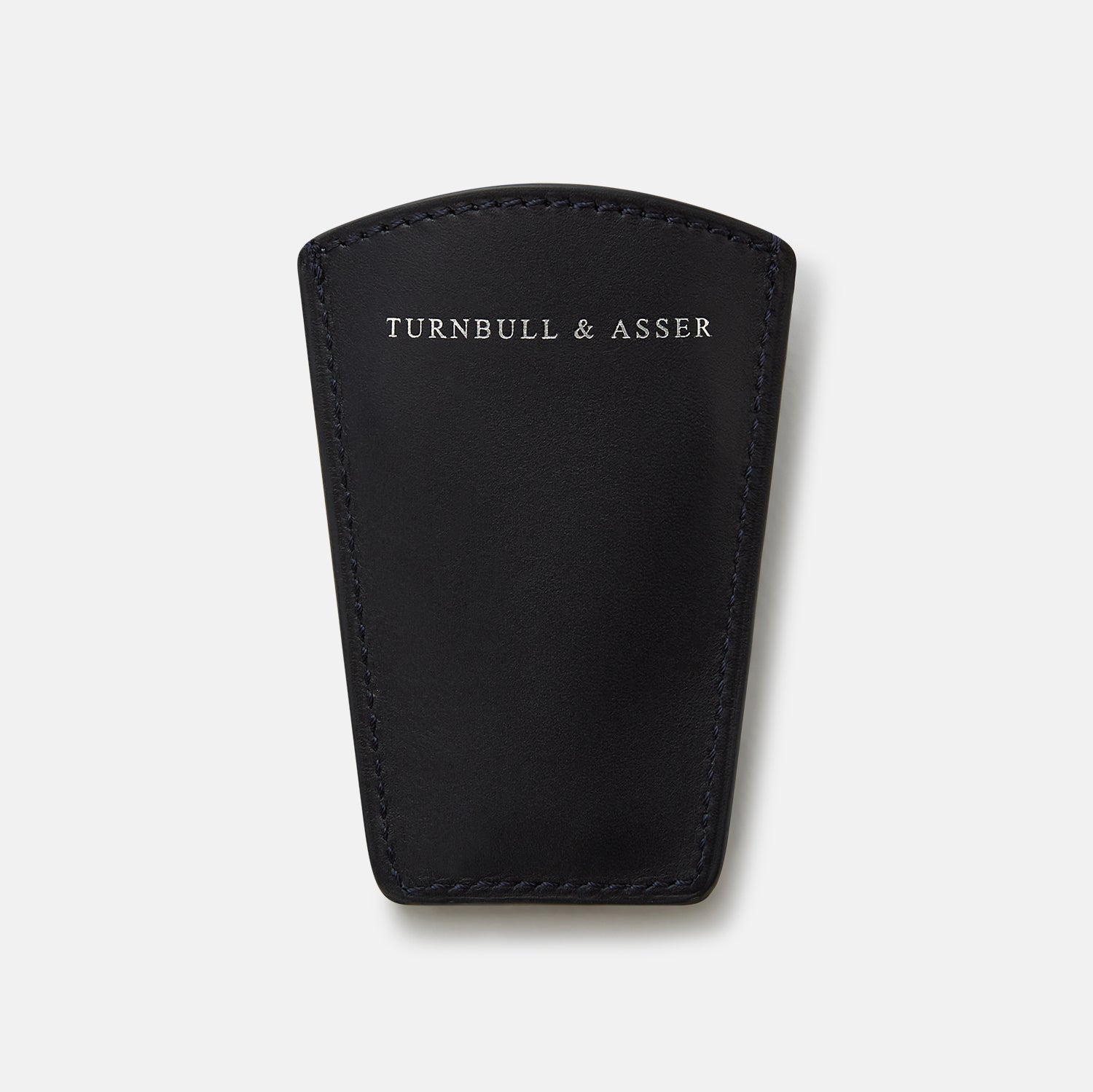 View 4 of product The Turnbull & Asser Navy Travel Shoe Horn features a wide, smooth silver blade and a navy leather-wrapped handle, shown against a plain white background.