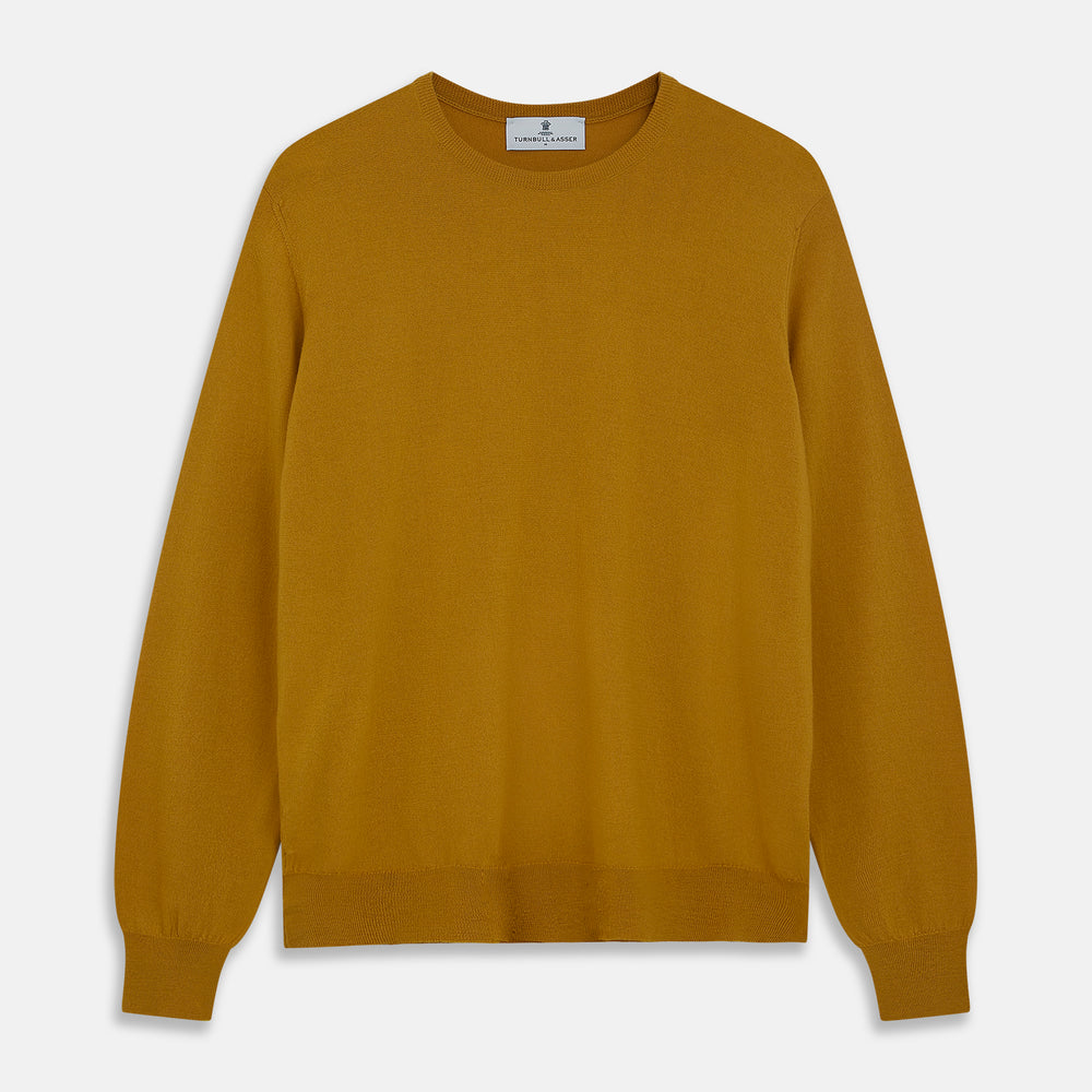 The Turnbull & Asser Gold Crew Neck Merino Jumper, featuring long sleeves and ribbed cuffs and hem, is displayed flat on a white background.