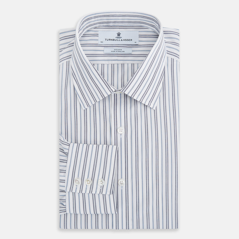The Turnbull & Asser Navy Multi Stripe Mayfair Shirt features a T&A collar and premium Italian cotton, with vertical blue and white stripes. It is shown neatly laid flat on a white background.