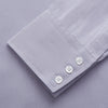 View 3 of product The Turnbull & Asser Lilac Silk Regular Fit Flaxton Shirt features long sleeves, a classic collar, white buttons, and a curved hem, shown laid flat on a white background.