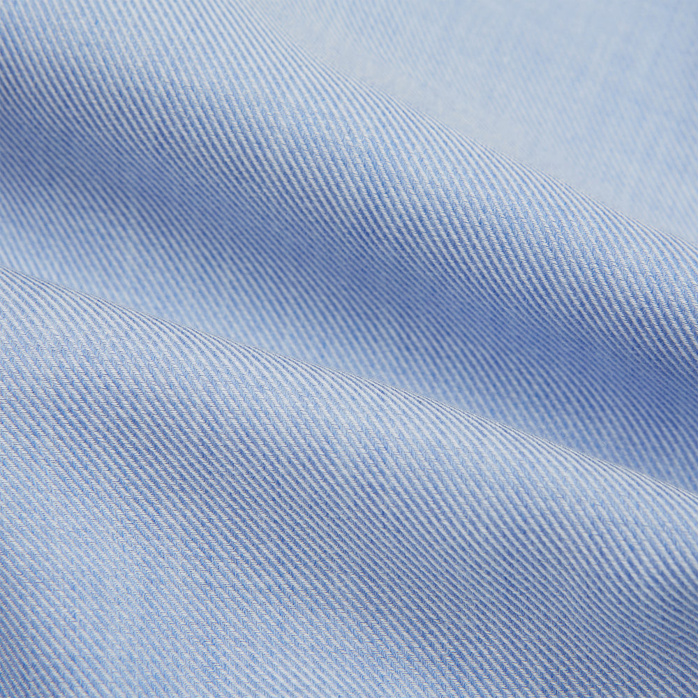 The Turnbull & Asser Pale Blue Cotton Cashmere Dorset Collar Richmond Shirt features long sleeves, a button-down collar, white buttons, and a chest pocket. It is neatly displayed flat on a white background.