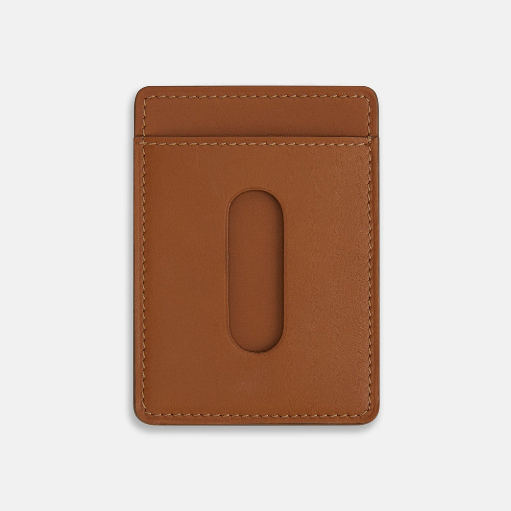 The Camel Two-slot Card Case by Turnbull & Asser is crafted from Italian leather with white stitching, featuring a front pocket and the brand’s logo embossed in white—a sleek accessory for everyday use.